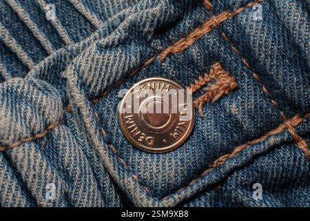 Button and seams of a denim garment Stock Photo
