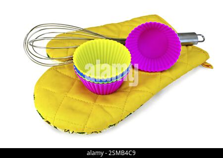 Colorful silicone molds for cupcakes, mixer on yellow cloth potholder isolated on white background Stock Photo