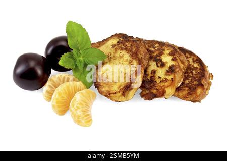 Three golden fried toast, two plums, three slices of mandarin, mint sprig isolated on white background Stock Photo