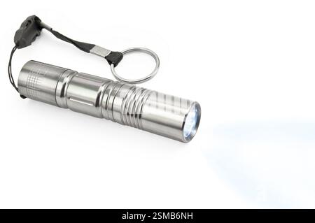 A small silver lamp, a beam of blue light isolated on white background Stock Photo