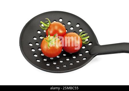 Three small red tomatoes on black plastic skimmer isolated on white background Stock Photo