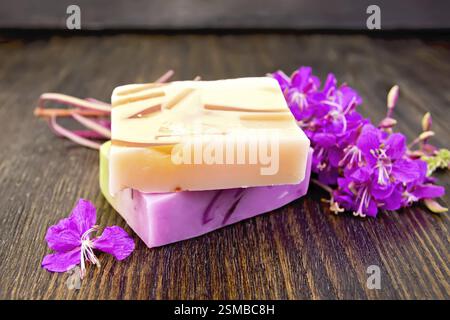 Two bars of homemade soap with fireweed flowers on the background of wooden boards Stock Photo