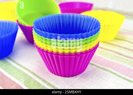 Colorful silicone molds for cupcakes on linen background Stock Photo