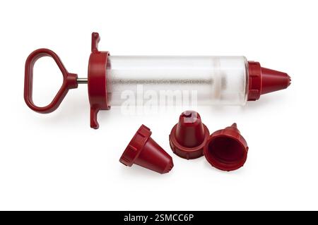 Confectionery syringe with replaceable nozzles isolated on a white background Stock Photo