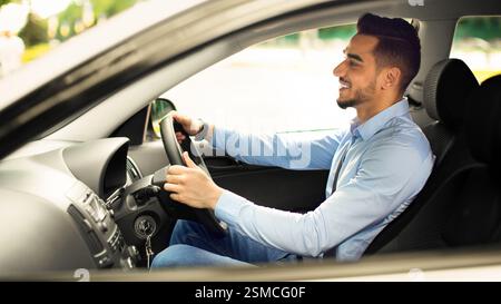 Attractive arabic guy enjoying driving, going to job Stock Photo
