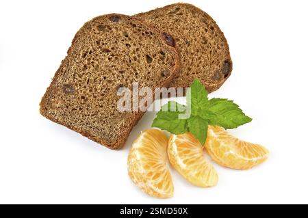 Two slices of rye bread with raisins, three segment of mandarin, mint sprig isolated on a white background Stock Photo
