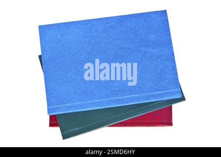 A stack of notebooks blue, green and red hardback isolated on a white background Stock Photo