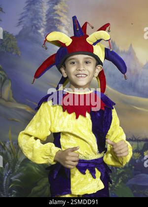 South Asian Indian boy dressed as joker performing fancy dress competition on stage in nursery school MR Stock Photo