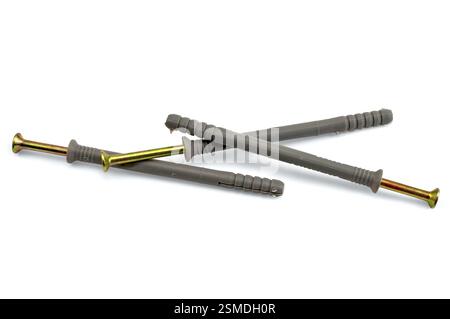 Three dowel screws with yellow nails and gray plastic plugs isolated on white background Stock Photo