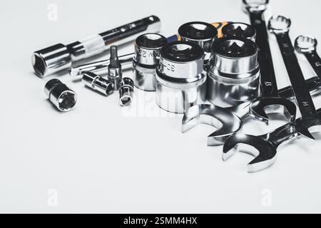 Assortment of shiny tools including sockets and wrenches on a light background for mechanic work or DIY projects Stock Photo