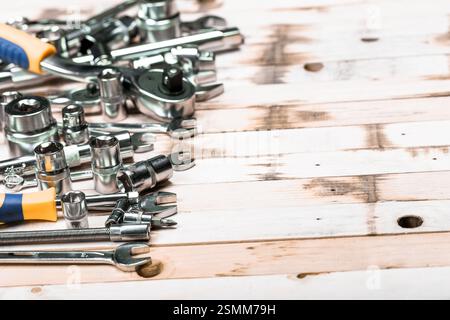 Collection of various hand tools displayed on a rustic wooden surface in a workshop setting, showcasing craftsmanship and utility Stock Photo