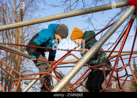 Two boys playing on the playground in the spring Stock Photo