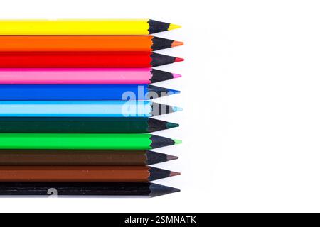 Collection of colored pencils arranged in a neat row on a white background for art and creativity Stock Photo