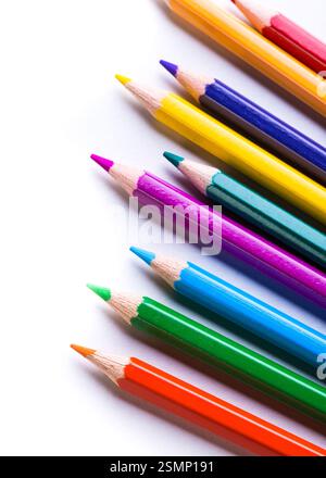 Colorful pencils arranged in a vibrant diagonal line on a white background Stock Photo