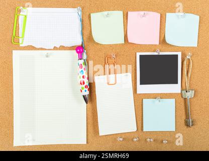 Colorful stationery and notes organized on a corkboard in a home office setting Stock Photo
