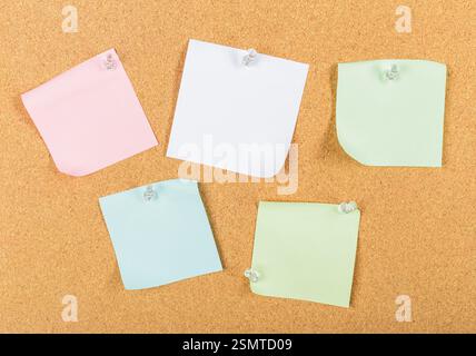 Colorful sticky notes arranged on a corkboard for reminders and organization Stock Photo