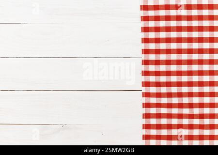 Red and white checkered tablecloth on wooden surface creating a cozy dining atmosphere Stock Photo