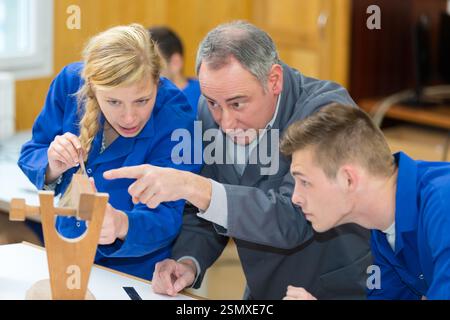 carpenter with students in woodworking workshop Stock Photo