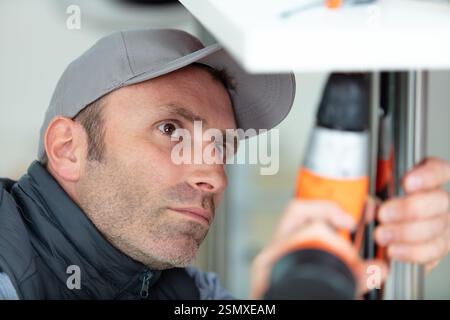 close view of man using cordless drill Stock Photo