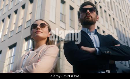 Two stylish business colleagues coworkers businesspeople Caucasian businessman male man entrepreneur guy with woman female girl businesswoman posing Stock Photo