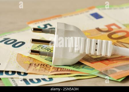 White electric plug on euro banlnotes - Concept of electricity priices and costs in Europe Stock Photo