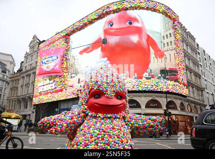 EDITORIAL USE ONLY The 'Gummy Monster' mascot hands out samples of