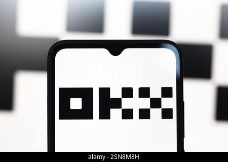 In this photo illustration, the OKX logo is seen displayed on a smartphone screen. Stock Photo