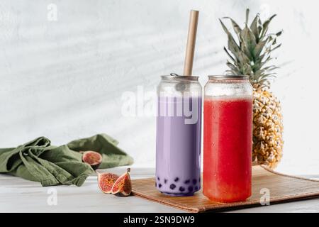 Two Refreshing Purple bubble tea with boba pearls in to-go cups,, summer refreshing drinks Stock Photo