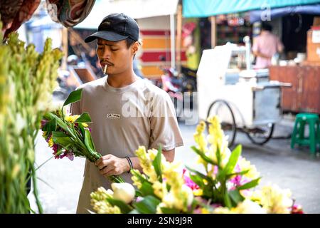 Worker at his stall selling flowers, street scene in chinatown Jakarta, Java, Indonesia Stock Photo