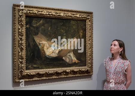London, UK. 13th Feb, 2025. LONDON, UNITED KINGDOM - FEBRUARY 13, 2025: A staff member looks at a painting by Gustave Courbet titled 'The Hammock' (1844) during a photocall at The Courtauld Gallery as part of the new exhibition Goya to Impressionism: Masterpieces from the Oskar Reinhart Collection in London, United Kingdom on February 13, 2025. (Photo by WIktor Szymanowicz/NurPhoto) Credit: NurPhoto SRL/Alamy Live News Stock Photo
