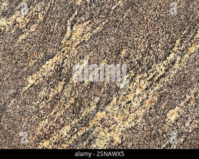 Close up of random brown marble with black and beige veins diagonally. Natural marble or granite stone texture with black grains. Seamless background Stock Photo