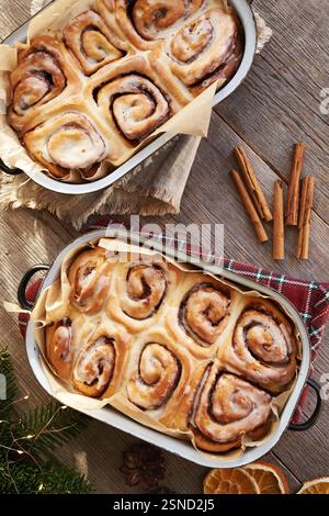 Homemade cinnamon rolls in two baking pans on a table, top view Stock Photo