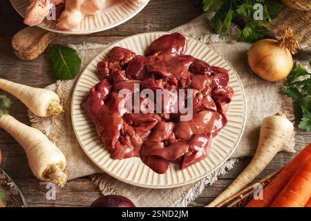 Chicken liver, meat and fresh vegetables - Ingredients for bone broth or soup Stock Photo