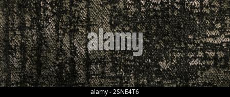 Dark brown fluffy background of soft, fleecy fabric, macro. Texture of umber velveteen textile backdrop with shiny pattern, closeup. Stock Photo