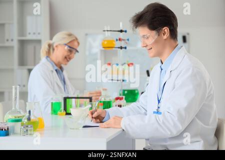Male chemist working at table in laboratory Stock Photo