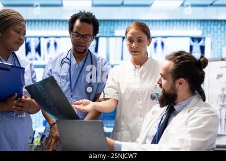 Diverse team of healthcare providers reviewing test lab results in a ...