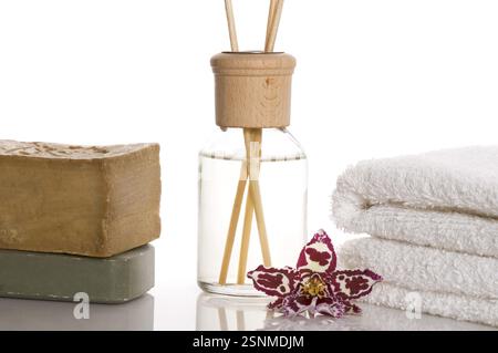 Aroma therapy objects. bottle of esential oil, candles, towels, soap, orchid Stock Photo