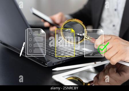 Electronic document check and data information searching online, files manager concept. Yellow documents file icon appear on magnifying glass in busin Stock Photo