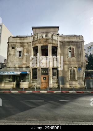 An old historical building to be renovated with a construction of a new residential building behind it. Hayarkon street, Tel Aviv, Israel. Stock Photo