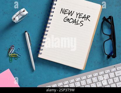 Notebook with new year goals written on it, placed on office desk, planning future strategy Stock Photo
