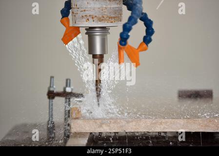 Robot working on milling sculpture in natural stone Stock Photo