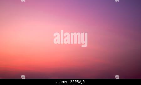 Background image of sky gradient with beautiful pastel pink and orange and purple in the evening as the sun sets, Colorful clouds in summer, Peaceful Stock Photo