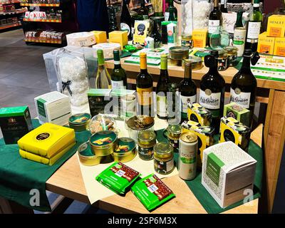 Lviv, Ukraine - February 13, 2025: Various gourmet food items and beverages organized on a store wooden table display Stock Photo