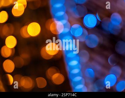 Abstract image of colorful bokeh lights in orange and blue hues, creating a vibrant and festive atmosphere. Stock Photo