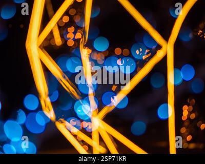 Abstract image featuring blurred blue and orange bokeh lights with geometric shapes. Stock Photo