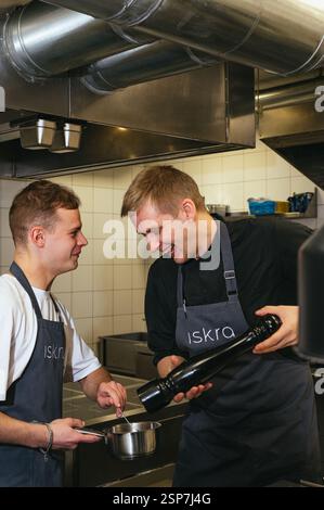 two young chefs in the kitchen Stock Photo
