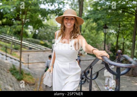 Smiling woman strolling through the scenic streets of Montmartre Stock Photo