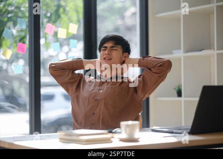 Tired worker experiencing neck and shoulder pain prolonged work hours Stock Photo