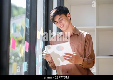Young businessman analyzing financial data and market trends Stock Photo