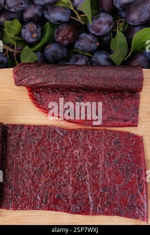Fruit leather and rolls. Homemade or handmade pastille on the wooden board. Stock Photo